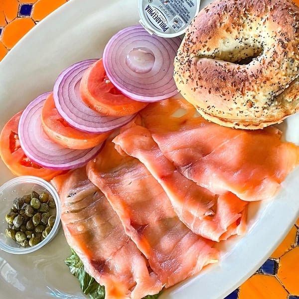 Lazy Daisy's lox and bagel with capers, red onion, tomatoes, and cream cheese.