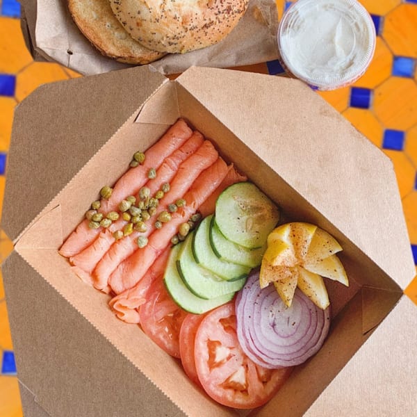 Lazy Daisy's lox and bagel kit with smoked salmon, capers, cucumber, tomato, onion, and lemon.