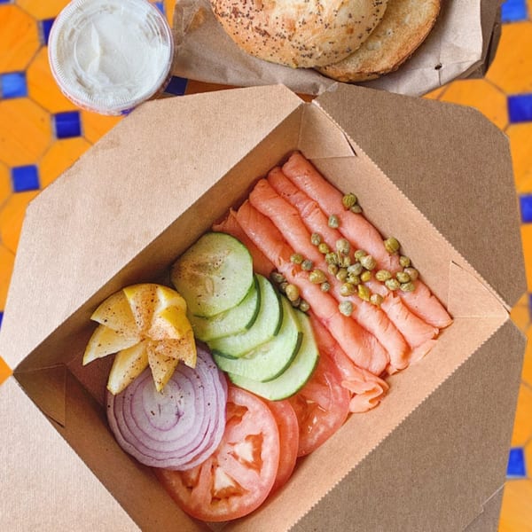 Lazy Daisy's lox and bagel kit with salmon, capers, cucumber, tomato, onion, and lemon.
